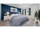 Comfortable primary bedroom with a large window, soft lighting, and a calming blue accent wall at 1511 Barberry Dr, Kissimmee, FL 34744