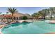 Beautiful community pool with beach entry, lounge chairs, sun umbrellas and ample seating at 1511 Barberry Dr, Kissimmee, FL 34744