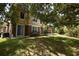 Backyard view featuring a grassy lawn and the building's exterior, complemented by mature trees and landscaping at 15349 Oak Apple Ct # B, Winter Garden, FL 34787