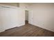 Bedroom features wood-look flooring, closet, neutral walls, and an open doorway at 15349 Oak Apple Ct # B, Winter Garden, FL 34787