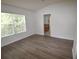 Comfortable bedroom with wood-look flooring and natural light from a large window at 15349 Oak Apple Ct # B, Winter Garden, FL 34787