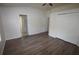 Neutral bedroom showcasing wood-look floors, closet, and an en-suite bathroom at 15349 Oak Apple Ct # B, Winter Garden, FL 34787