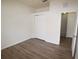 Bedroom features wood-look flooring, closet, and an open doorway to another room at 15349 Oak Apple Ct # B, Winter Garden, FL 34787