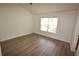 Bright bedroom with wood-look flooring and a window allowing ample natural light at 15349 Oak Apple Ct # B, Winter Garden, FL 34787