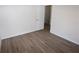 Bedroom with wood-look flooring, neutral paint, baseboards, and an open doorway at 15349 Oak Apple Ct # B, Winter Garden, FL 34787