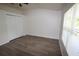 Well-lit bedroom featuring wood-look flooring, a window, and a spacious closet at 15349 Oak Apple Ct # B, Winter Garden, FL 34787