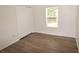 Bedroom featuring closet, natural light, wood-look flooring, and baseboards at 15349 Oak Apple Ct # B, Winter Garden, FL 34787