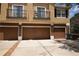 Townhouse showcasing attached garages, ample parking, and a neutral exterior paint scheme under a sunny sky at 15349 Oak Apple Ct # B, Winter Garden, FL 34787