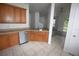 Well-lit kitchen with stainless steel appliances, wooden cabinets, open layout to dining area at 15349 Oak Apple Ct # B, Winter Garden, FL 34787