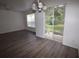 Bright living space with sleek flooring, a sliding glass door, and recessed lighting, enhancing the open layout at 15349 Oak Apple Ct # B, Winter Garden, FL 34787