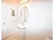 Bathroom sink with decorative mirror and lighting at 15349 Oak Apple Ct, Winter Garden, FL 34787