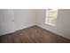 Bright bedroom features wood floors and a window with blinds, enhancing its appeal at 15349 Oak Apple Ct, Winter Garden, FL 34787