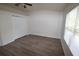 Inviting bedroom features wood-look flooring, a large window, and double door closet at 15349 Oak Apple Ct, Winter Garden, FL 34787