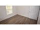 Bright bedroom with wood-look flooring and a window for natural light at 15349 Oak Apple Ct, Winter Garden, FL 34787