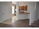 This view looks through the front door into the kitchen with breakfast bar, tile flooring, and stainless steel appliances at 15349 Oak Apple Ct, Winter Garden, FL 34787