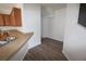 Open kitchen area featuring a double sink, wood cabinets, and access to other rooms at 15349 Oak Apple Ct, Winter Garden, FL 34787