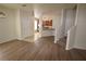 Open-concept living room boasts wood floors, neutral paint, and easy access to kitchen and staircase at 15349 Oak Apple Ct, Winter Garden, FL 34787