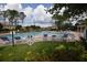 Community pool with ample seating and lush landscaping provides a relaxing atmosphere at 15349 Oak Apple Ct, Winter Garden, FL 34787