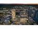Stunning aerial view showcasing the vibrant city skyline at dusk with an outdoor pool on the building at 155 S Court Ave # 1608, Orlando, FL 32801