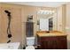 Well-lit bathroom featuring a modern vanity, granite countertops, and tiled shower at 155 S Court Ave # 1608, Orlando, FL 32801
