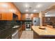 Modern kitchen with granite countertops, stainless steel appliances, and dark wood cabinetry at 155 S Court Ave # 1608, Orlando, FL 32801