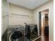 Functional laundry room with updated appliances and practical storage shelving at 155 S Court Ave # 1608, Orlando, FL 32801