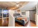 Spacious main bedroom featuring hardwood floors, a large window, and a modern barn door at 155 S Court Ave # 1608, Orlando, FL 32801