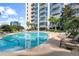 Refreshing outdoor pool surrounded by lounge chairs and lush greenery at 155 S Court Ave # 1608, Orlando, FL 32801