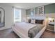Modern bedroom featuring a stylish bed with striped bedding and a white throw blanket at 1558 Dalehurst Ln, Kissimmee, FL 34744