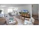 Spacious open-concept living area featuring a modern kitchen, hardwood floors, and stylish furnishings for comfortable living at 1562 Dalehurst Ln, Kissimmee, FL 34744