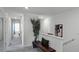 Bright hallway with carpeted floors and neutral walls, enhanced by a decorative bench and wall art at 1566 Dalehurst Ln, Kissimmee, FL 34744