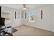 Bright bedroom with a ceiling fan, neutral carpet, white walls, and plentiful natural light at 1744 Pine Ridge Dr, Davenport, FL 33896