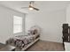 Bedroom featuring a twin bed, ceiling fan, and large window providing natural light at 1744 Pine Ridge Dr, Davenport, FL 33896