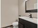 Powder room featuring a modern vanity with a black faucet and a decorative mirror above at 1744 Pine Ridge Dr, Davenport, FL 33896
