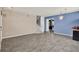 Spacious living room with gray wood floors, an accent wall, and staircase to the second floor at 1744 Pine Ridge Dr, Davenport, FL 33896