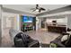 Spacious living room with hardwood floors, gray walls, a ceiling fan, and a kitchen view at 1744 Pine Ridge Dr, Davenport, FL 33896