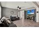 Stylish living room with hardwood floors, comfortable seating, modern décor, and an open layout connecting to the dining and kitchen areas at 1744 Pine Ridge Dr, Davenport, FL 33896