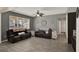 Comfortable living room featuring hardwood floors, two recliners, a ceiling fan, and natural light, creating a cozy and inviting atmosphere at 1744 Pine Ridge Dr, Davenport, FL 33896