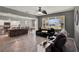 Open-concept living room boasts hardwood floors, and modern lighting, seamlessly connected to a kitchen and dining area at 1744 Pine Ridge Dr, Davenport, FL 33896