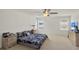 Spacious main bedroom with ceiling fan, neutral carpet, and plenty of natural light at 1744 Pine Ridge Dr, Davenport, FL 33896