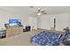 Spacious main bedroom with ceiling fan, neutral carpet, and plenty of natural light at 1744 Pine Ridge Dr, Davenport, FL 33896