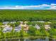 Wide aerial view showcasing the community near a lake, featuring mature trees and well-maintained landscaping at 1846 Branchwater Trl, Orlando, FL 32825