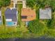 Aerial view of a home with a pool, solar panels and a serene lake in a well-maintained neighborhood at 1846 Branchwater Trl, Orlando, FL 32825