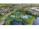 An aerial view captures the community pool, tennis courts, and playground nestled in a beautiful community at 1846 Branchwater Trl, Orlando, FL 32825