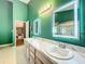 Bathroom featuring a glass shower reflected in the dual sink vanity mirrors at 1846 Branchwater Trl, Orlando, FL 32825
