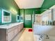 Bathroom featuring a glass shower, a soaking tub, and a dual sink vanity with marble countertops at 1846 Branchwater Trl, Orlando, FL 32825