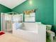 Bathroom featuring a glass shower, a soaking tub, and a toilet at 1846 Branchwater Trl, Orlando, FL 32825