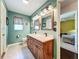 Bathroom featuring a dual sink vanity with wood cabinets and granite countertops at 1846 Branchwater Trl, Orlando, FL 32825