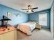 Bedroom with a ceiling fan, window, and minimal decor at 1846 Branchwater Trl, Orlando, FL 32825