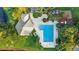An aerial shot displays the community pool, playground, and a clubhouse amid green spaces at 1846 Branchwater Trl, Orlando, FL 32825